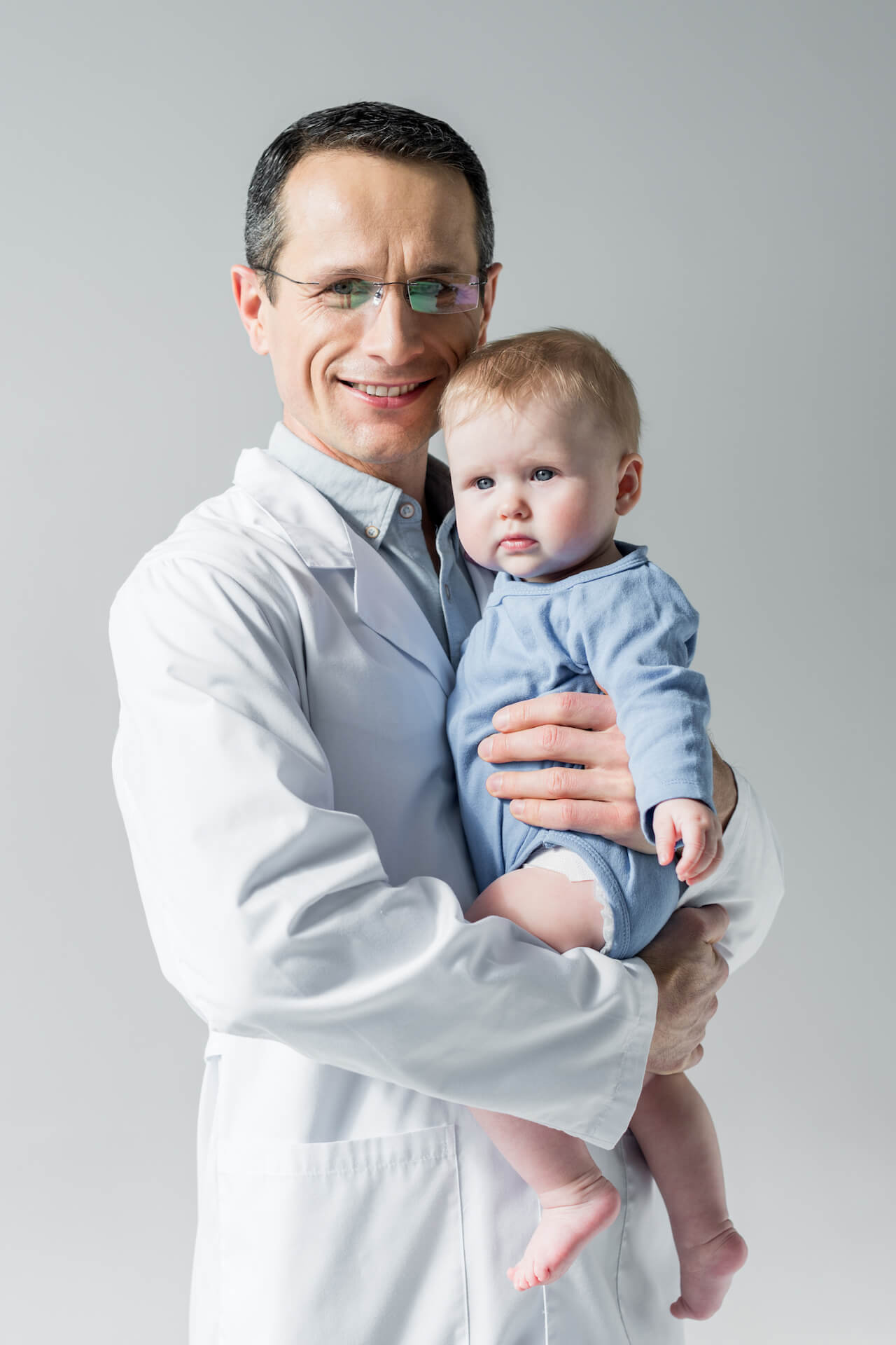 handsome-adult-pediatrician-holding-little-baby-an-2022-12-16-21-09-27-utc.jpg